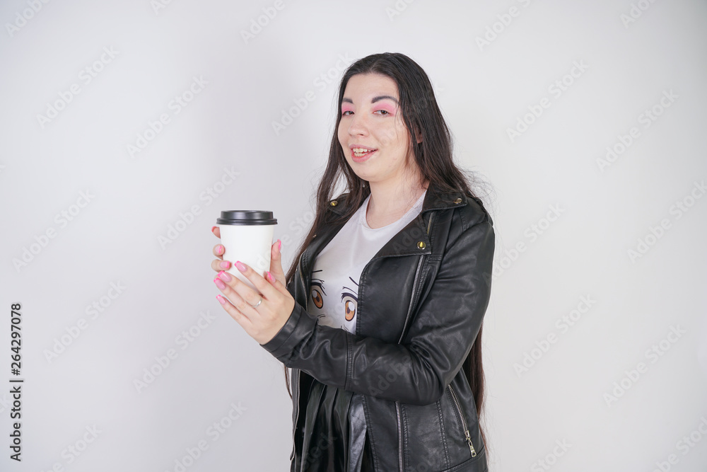 fashionable alternative girl with a paper Cup of coffee on a white background in the Studio fashionable alternative girl with a paper Cup of coffee on a white background in the Studio