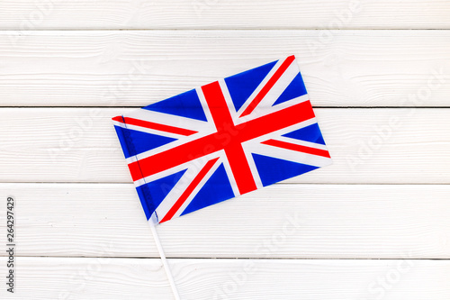 National day of United Kingdom of Great Britain concept with flag on white wooden background top view