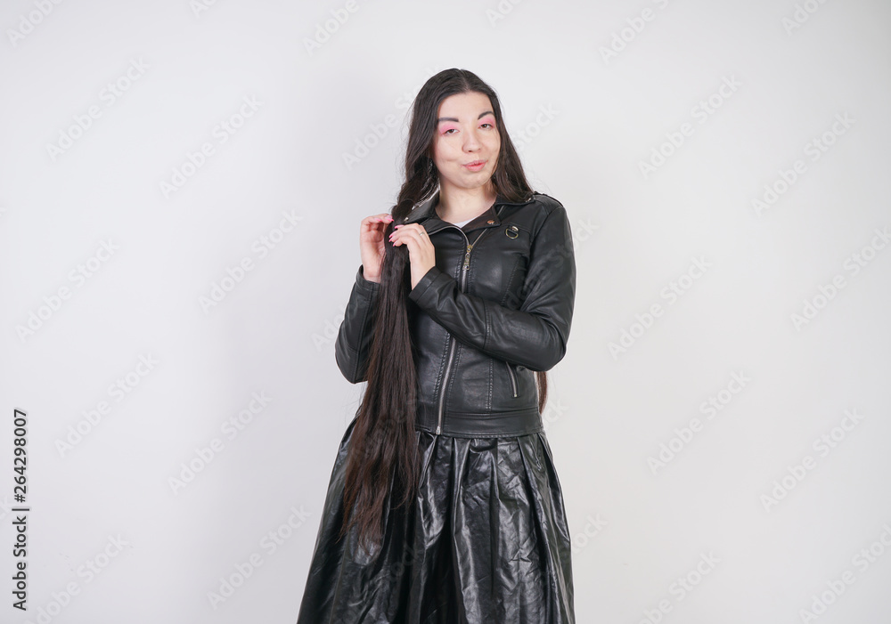pretty stylish curvy girl with very long brunette hair posing in letaher clothes on white background pretty stylish curvy girl with very long brunette hair posing in letaher clothes on white background