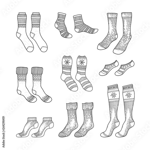 Black engraved socks drawing. Winter warm Christmas stockings set in ink hand drawn style vector illustration