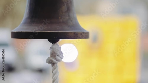 Ship copper bell with rope close-up. Boxing equipment. An announcer rings the bell during the annual Boxing tournament