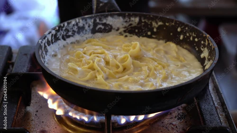 Pasta. Chef prepares pasta with cheese in a pan. Street restaurant. Spaghetti cheese sauce. Pasta. Chef prepares pasta with cheese in a pan. Street restaurant. Spaghetti cheese sauce.