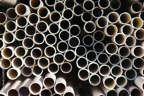 New plastic water pipes laid in a stack in the warehouse. 