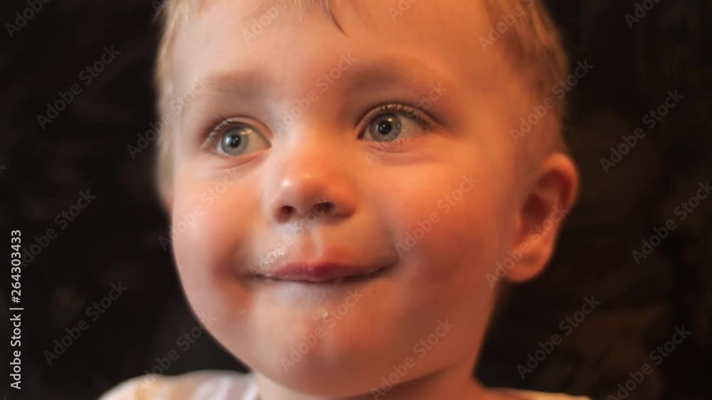 Portrait of a little hungry baby boy who tasting white vanilla ice cream in the waffle cup and his face smeared with ice cream in slow motion close up 4K video. Portrait of a little hungry baby boy who tasting white vanilla ice cream in the waffle cup and his face smeared with ice cream in slow motion close up 4K video.