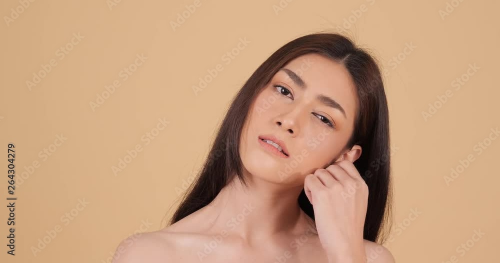 Portrait of beautiful Asian woman looking to camera with attractive smile. People with beauty and skin care concept. Portrait of beautiful Asian woman looking to camera with attractive smile. People with beauty and skin care concept.