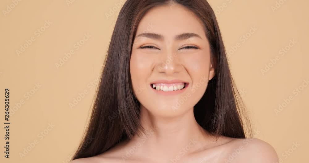 Portrait of beautiful asian woman looking to camera with attractive smile. People with beauty and skin care concept. Portrait of beautiful asian woman looking to camera with attractive smile. People with beauty and skin care concept.