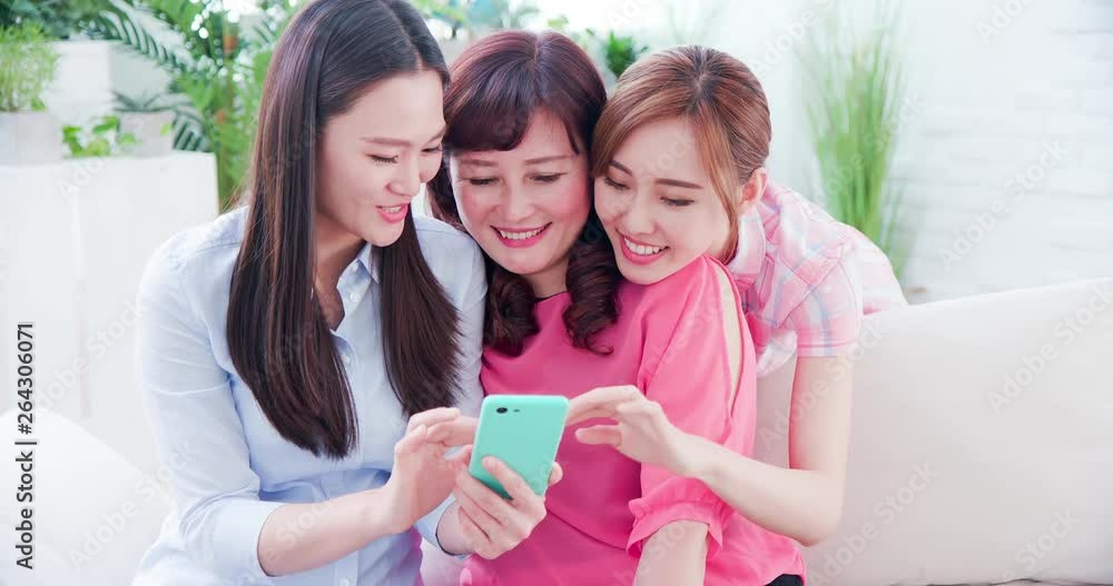 Daughters show smartphone to mom