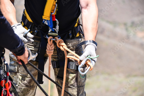 man with rapel, rock climbing in brazil, safety equipment for abseiling and climbing, abseiling in northeastern Brazil, strong man practicing extreme sport