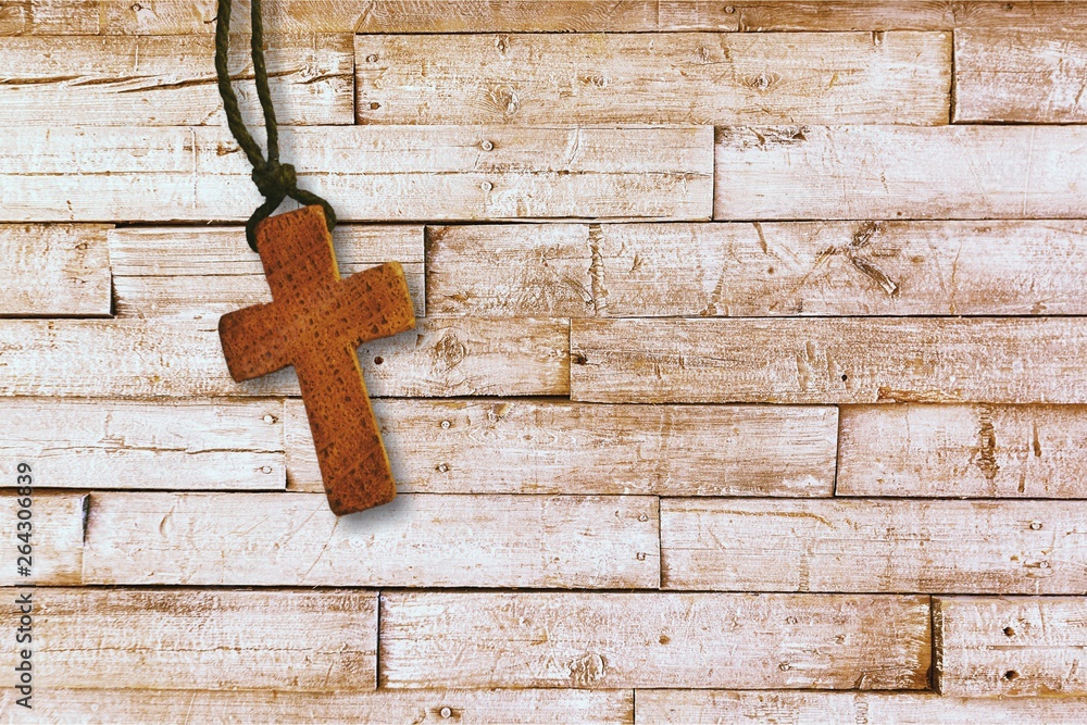 Christian wooden cross on desk
