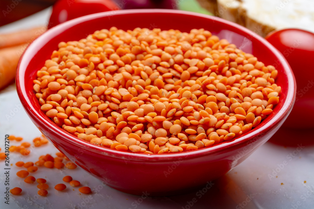 Dried orange lentils legume in red bowl Dried orange lentils legume in red bowl