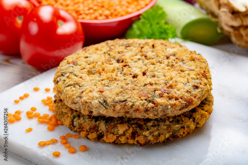Tasty vegetarian food, raw burgers made from lentils legumes with vegetables ready for cooking