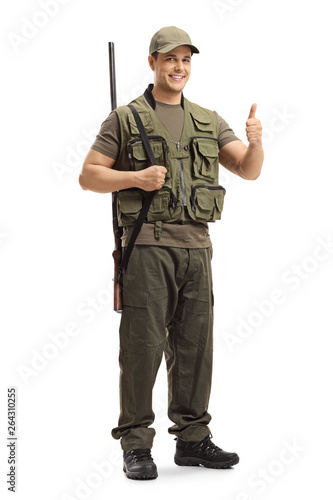 Hunter with a shotgun on his shoulder showing thumbs up sign