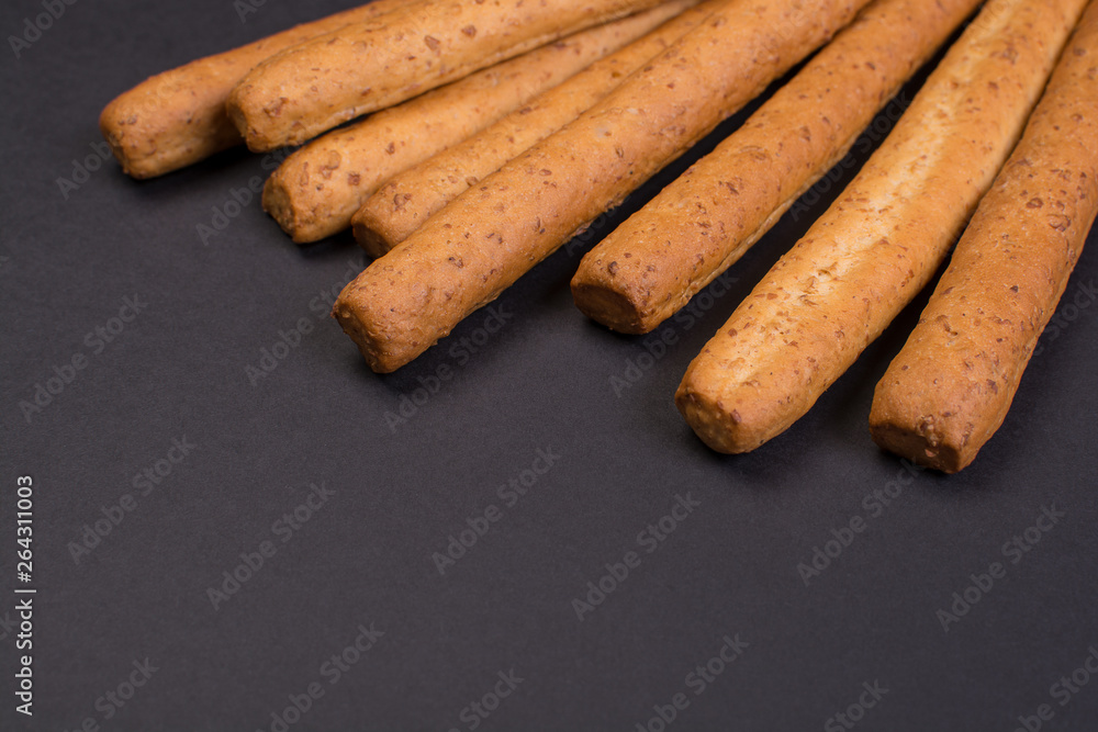Crispy bread sticks on a black background. Crispy bread sticks on a black background.