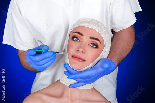 Konstfotografi Doctor cosmetologist makes rejuvenating facial injections procedure for tightening and smoothing wrinkles on face skin of beautiful, young woman in beauty salon