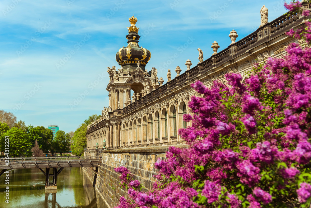 city of dresden. Zwinger Tower with a golden dome above the entrance. Canal and bridge
