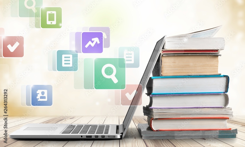 Stack of books with laptop on table Stack of books with laptop on table