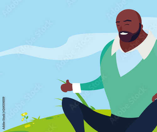black strong and bearded man seated in the field