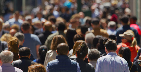 Crowd of people walking busy street in New York City