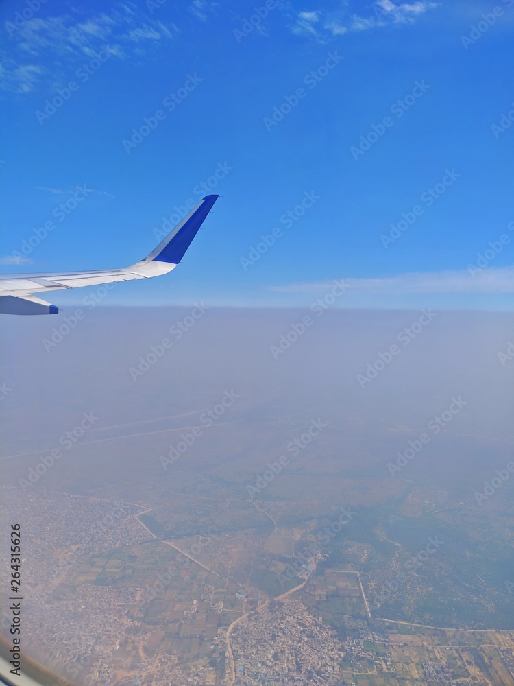 View from a plane window overlook a city. View from a plane window overlook a city.