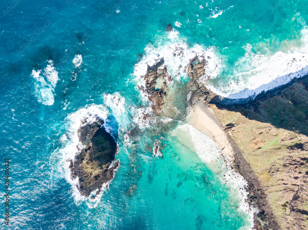 Stunning aerial drone view of the north eastern tip of Lord Howe Island near Malabar Hill. Beautiful white sand beach, waves and rocks in the water. Lord Howe belongs to New South Wales, Australia.