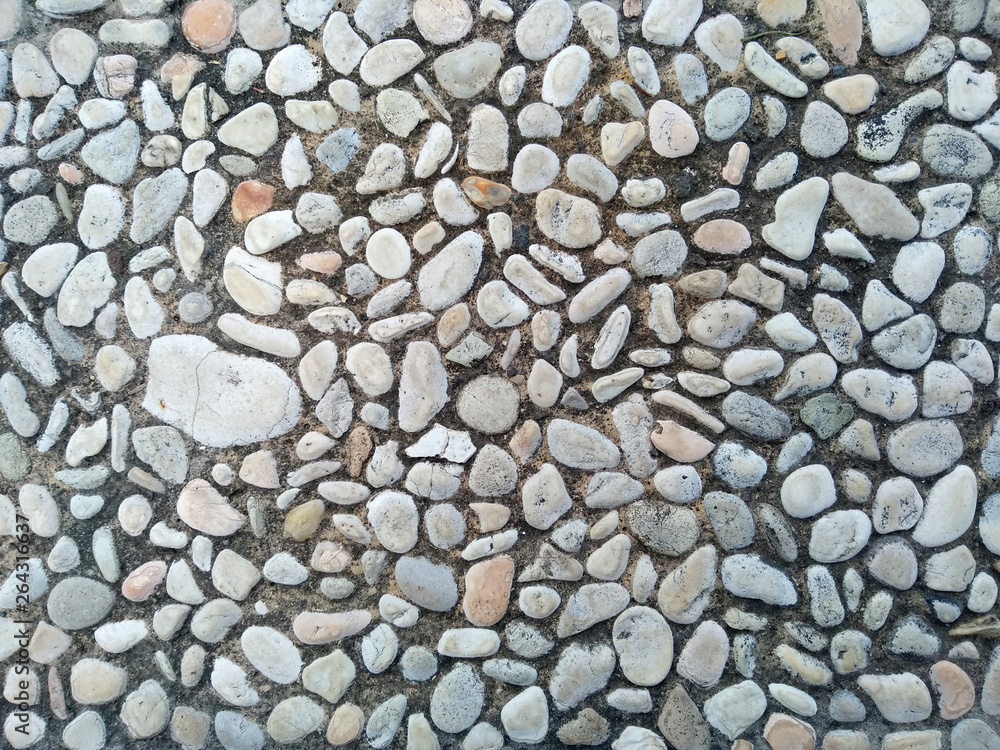 Gravel floor texture background. Floor background with stones. Rocks on the path for health. Round stone floor background. Gravel floor texture background. Floor background with stones. Rocks on the path for health. Round stone floor background.