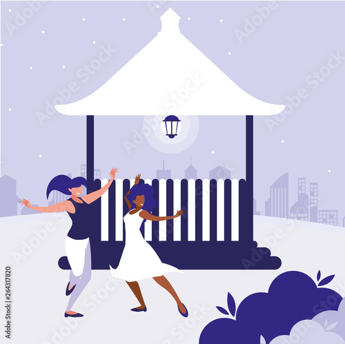 young interracial girls dancing in the park