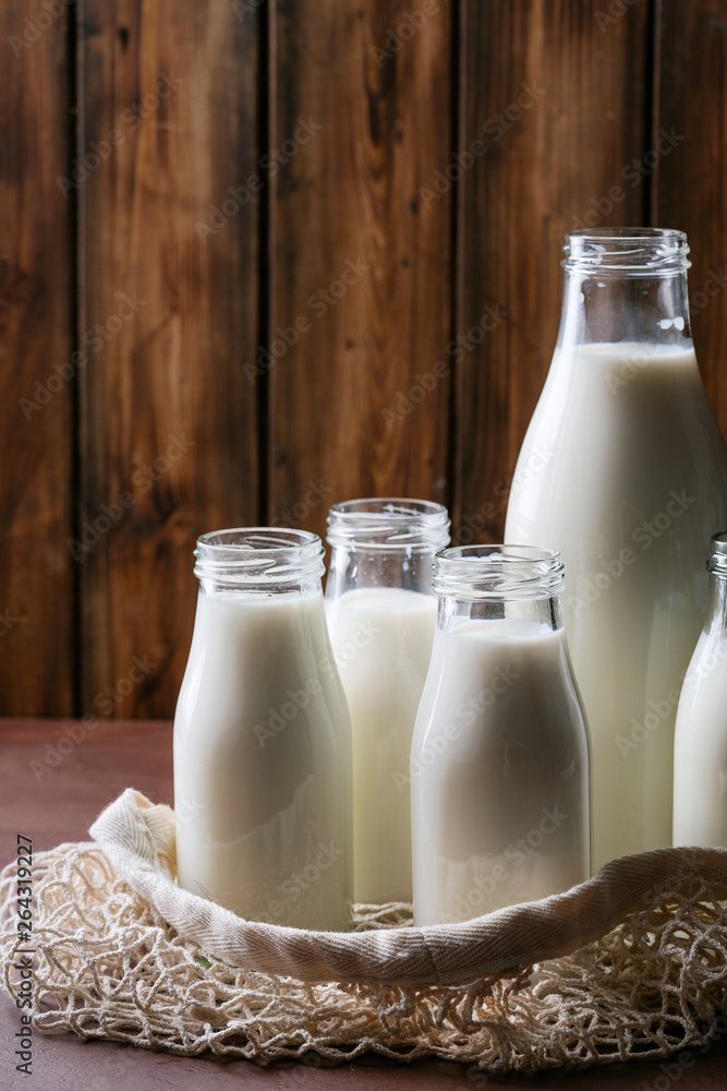 Fresh milk in different glass bottles Fresh milk in different glass bottles