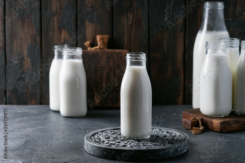 Fresh milk in different glass bottles