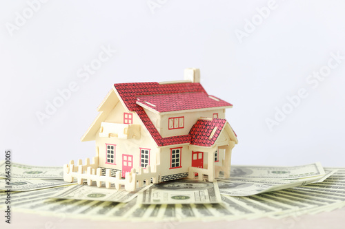 Business investment and real estate, Model house on banknote on white background, Saving for prepare in future