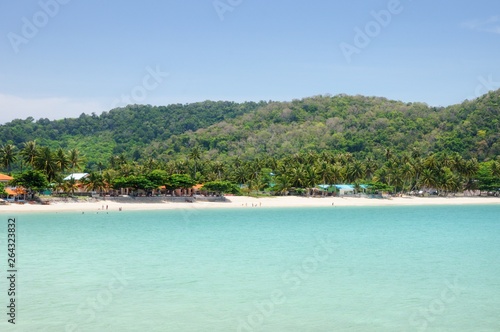Tropical turquoise sea bay, paradise sandy beach, palm trees, tourist resorts, Haad Kwang Pao Beach in Khanom district of Nakhon Si Thammarat province of Thailand.