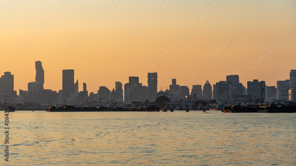 Silhouette of city inside the river at sunset