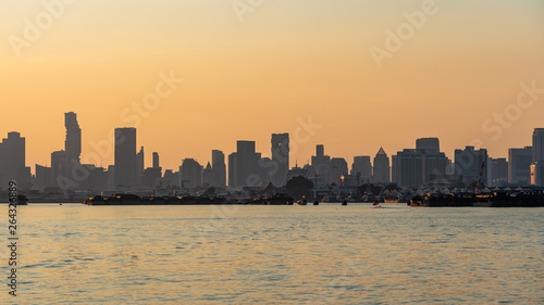 Silhouette of city inside the river at sunset © khamkula
