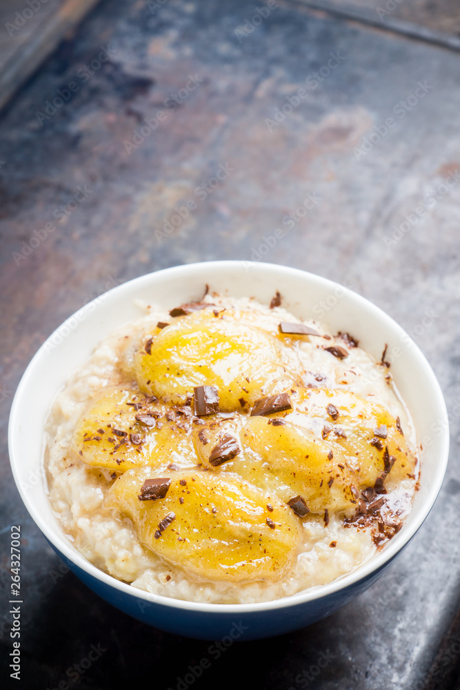 Oatmeal with roasted bananas and chocolate. Selective focus. Shallow depth of field. Oatmeal with roasted bananas and chocolate. Selective focus. Shallow depth of field.