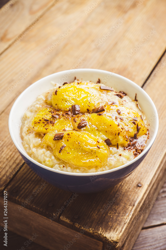 Oatmeal with roasted bananas and chocolate. Selective focus. Shallow depth of field. Oatmeal with roasted bananas and chocolate. Selective focus. Shallow depth of field.
