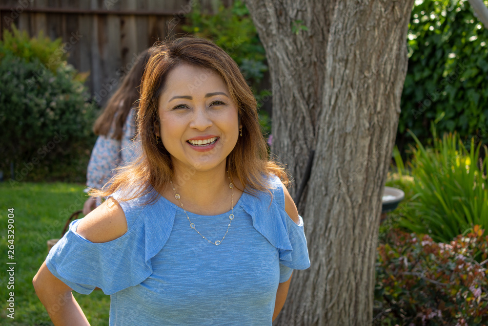 Latina Mother Smiling in Back Yard Latina Mother Smiling in Back Yard