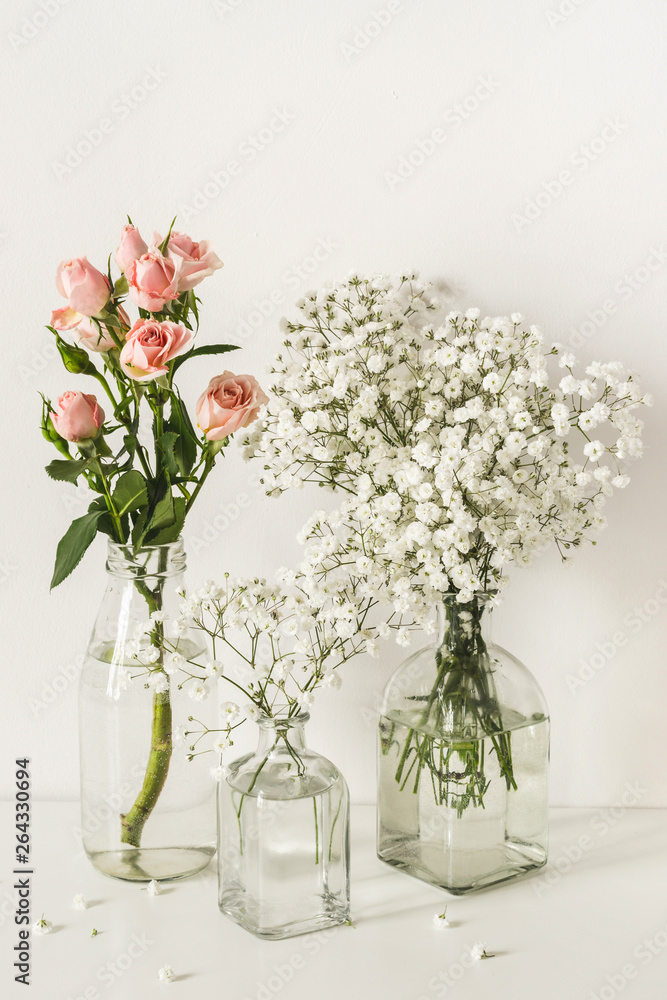 Fototapeta premium Romantic elegant wedding flowers arrangement on table wall background