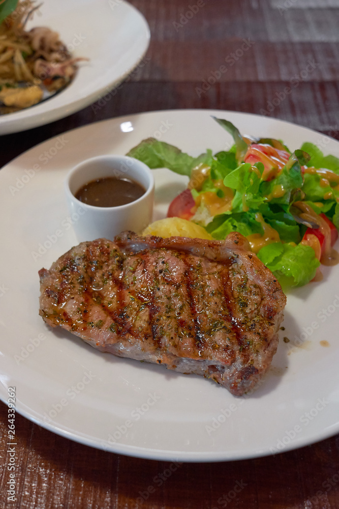 Barbecue Beef Steaks medium rare with grilled potaoes and vegetables. Barbecue Beef Steaks medium rare with grilled potaoes and vegetables.