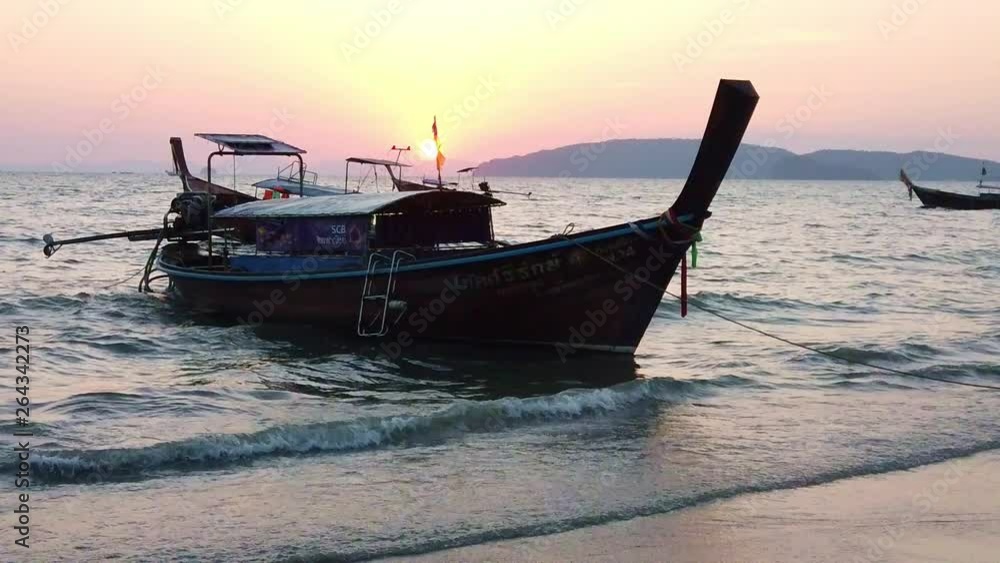 Long tail boat on the beach at sunset Long tail boat on the beach at sunset