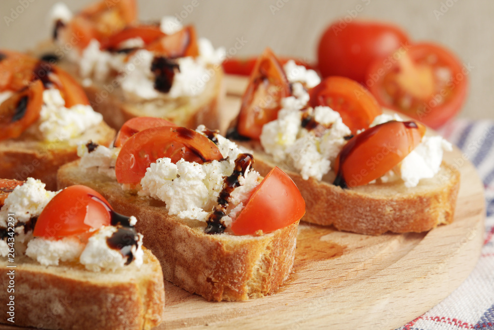 Sandwiches with tomatoes, homemade cheese, olive oil and balsamic sauce