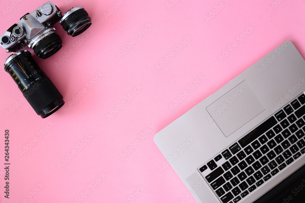 Office desk table with laptop,camera and lenses coffee. Top view, flat lay Office desk table with laptop,camera and lenses coffee. Top view, flat lay
