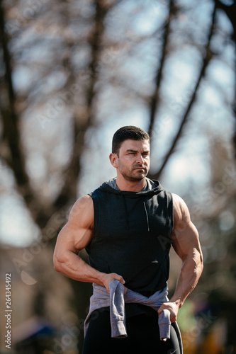 Athlete ready for a workout. Guy trains outdoors. Sportsman goes out to train.