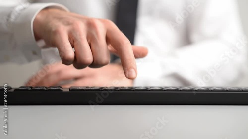 Businessman pressing a button on computer keyboard