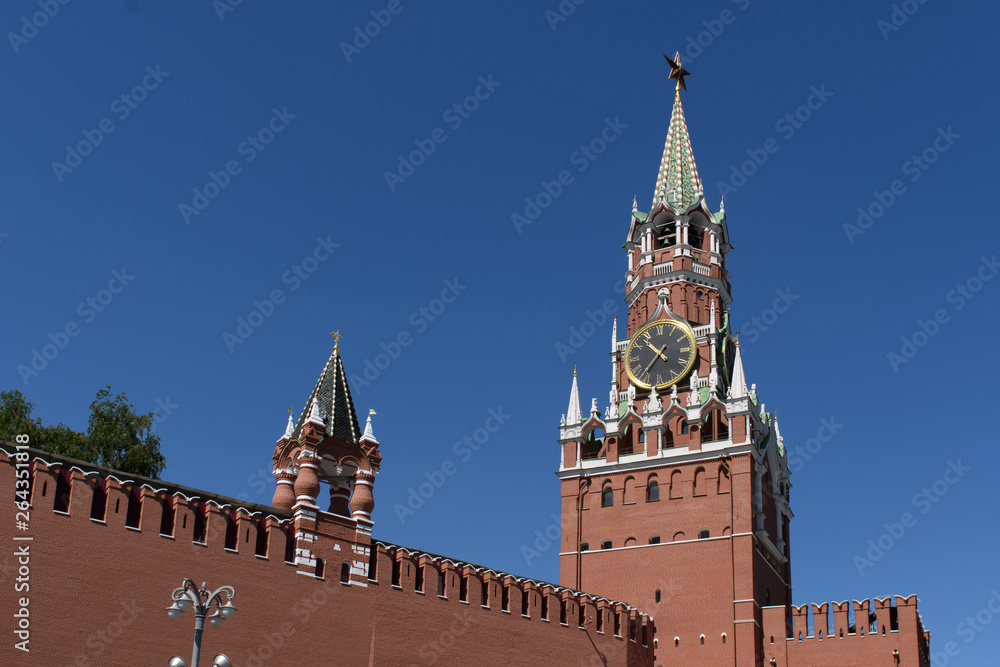Spasskaya tower of the Moscow Kremlin against a bright blue sky Spasskaya tower of the Moscow Kremlin against a bright blue sky