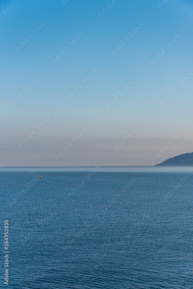 Tiny Fishing Boat on the Southern Italian Mediterranean Sea at Sunrise