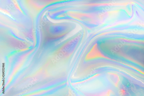 Abstract trendy holographic background. Real texture in pale violet, pink and mint colors with scratches and irregularities photo