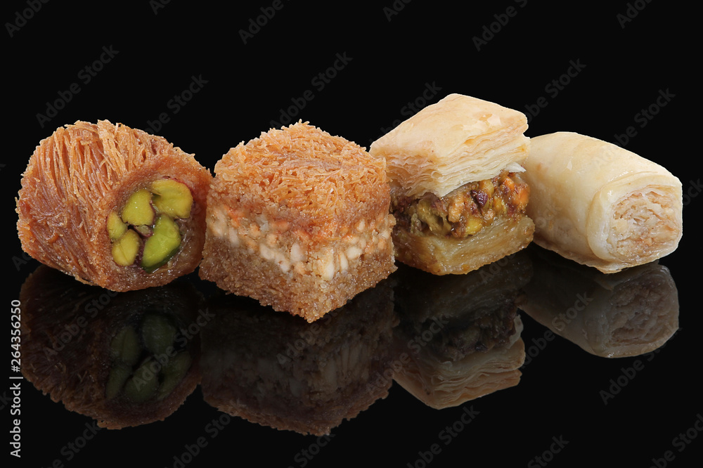 Middle eastern, Turkish sweet pastry baklava isolated on black background