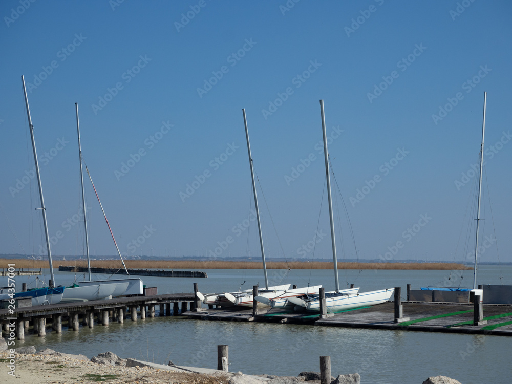 Fototapeta premium Sailboats moored to wood jetty