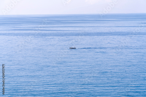 Motor boat in bright blue sea at a great distance concept of active recreation, holidays by the sea, entertainment and sea transport, fishing
