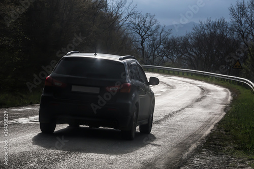 car moves along a winding mountain road © Yuri Bizgaimer