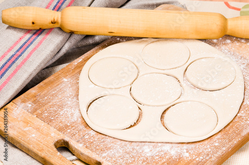 fresh raw dough and rolling pin